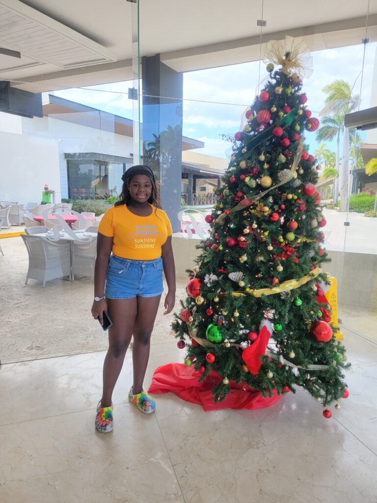 Posing by the Christmas tree at the hotel