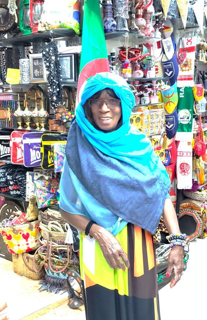Woman purchasing and trying on head scarf